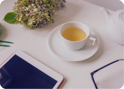 Laptop and tea on a desk